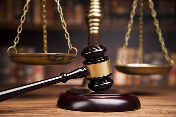 A gavel strikes the sound block in a workers comp lawsuit