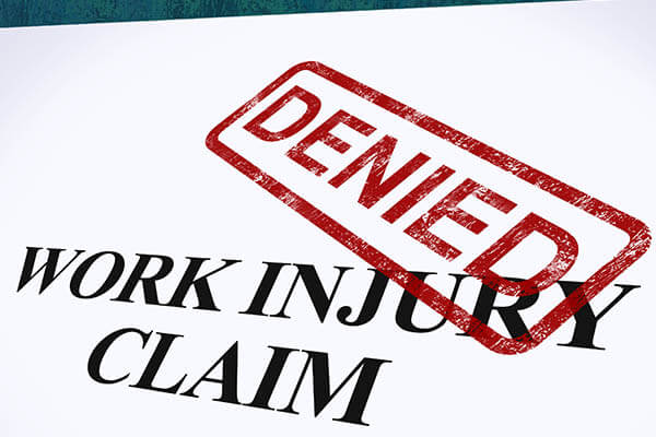 Workers comp claim with denied stamped on it