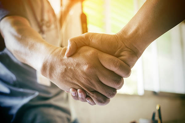 A handshake deal being made during workers comp mediation